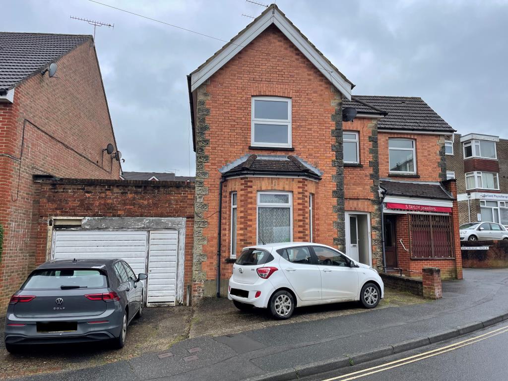 Lot: 156 - RETAIL UNIT AND WORKSHOP WITH GARAGE AND TWO FLATS - Main front elevation from Cantelupe Road